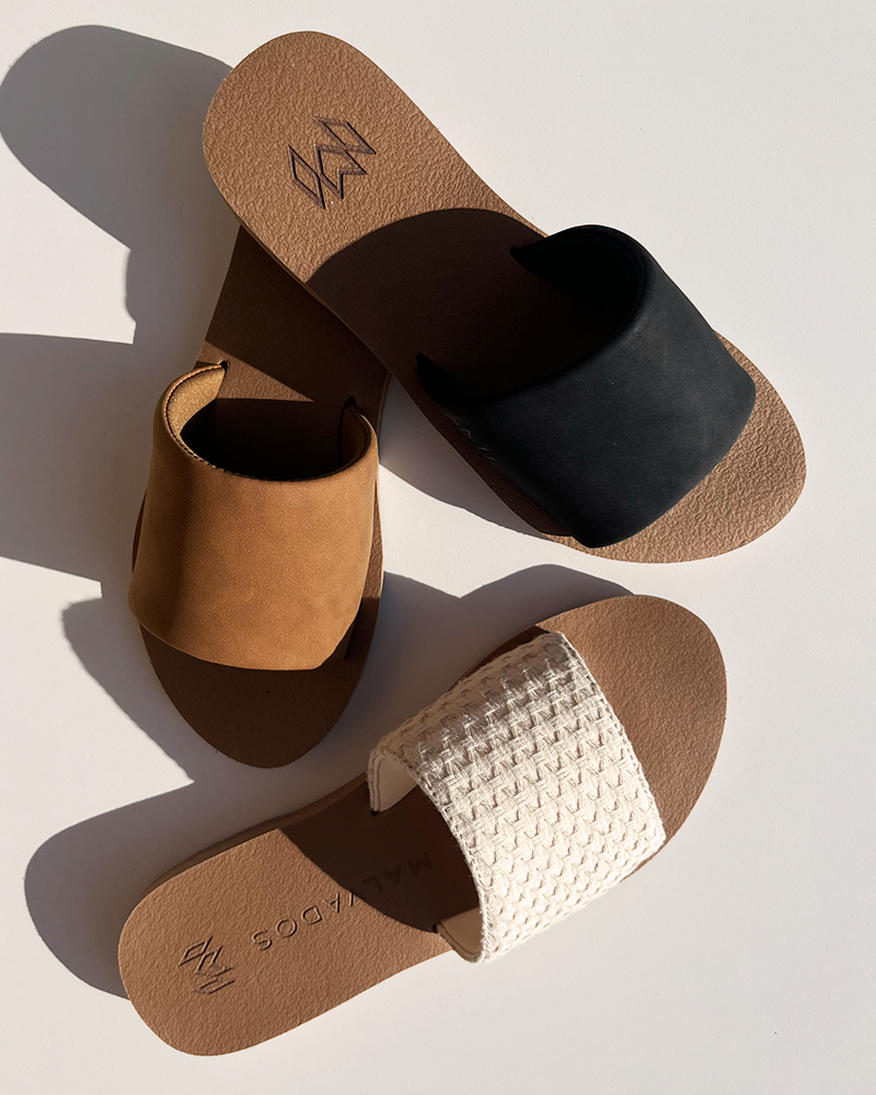 Group of slide sandals in black, white and brown